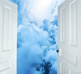 white doors opening to heavenly scene
