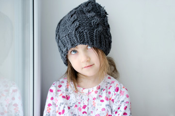 Adorable amaze kid girl in dark grey hat