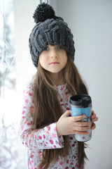 Adorable small girl indark grey hat