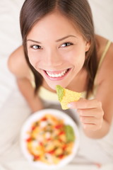 Woman eating nachos