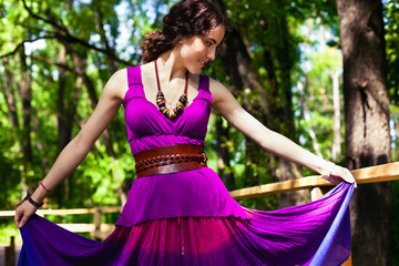 Girl in violet dress in park