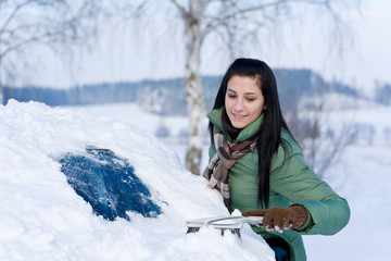 Winter car - woman remove snow from windshield