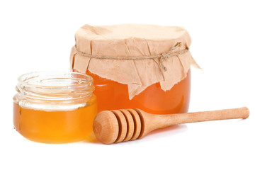 glass pot full of honey isolated on white