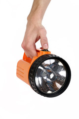 orange plastic flashlight in hand isolated on white background