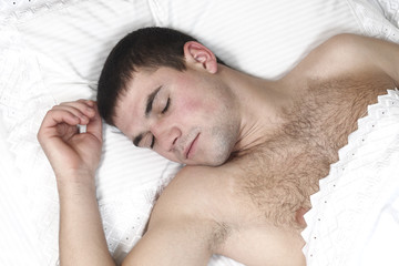 Fototapeta na wymiar a young boy sleeping in bed