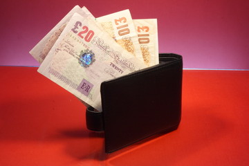 Wallet with banknotes on the red glass table