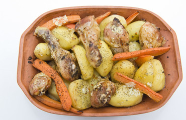 Roasted chicken and potatoes on a pot