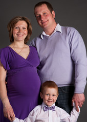 happy family with cute boy expecting another baby