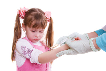 A doctor giving little girl an injection