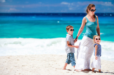 Mother with kids on tropical beach