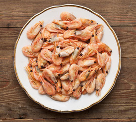 closeup of plate of shrimp on wood background