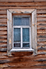 Obraz na płótnie Canvas Old rustic wall with a window. Fragment. Rural life.