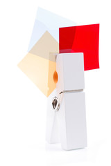 White peg holding three coloured square isolated