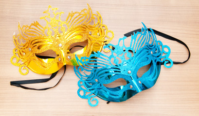 Ornate masks isolated on the wooden background