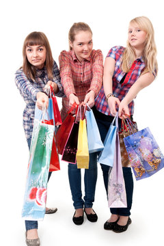 Three girls with colorful shopping bags