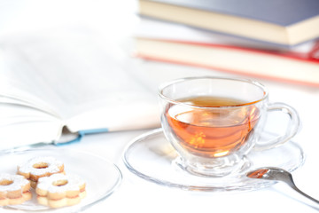 cookies, glass of tea and books on the table