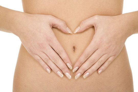 belly of a woman with hands around the navel