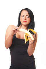 Fitness girl with banana isolated on white