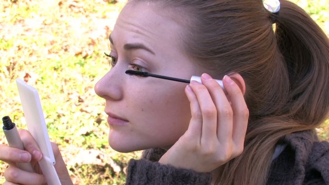 Young girl is doing eye makeup II