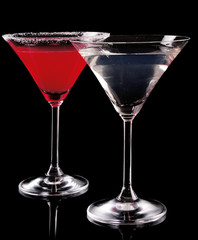 Martini glass with red coctail and with vodka on black backgroun