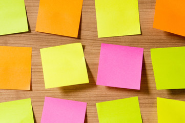 Many reminder notes on the wooden background