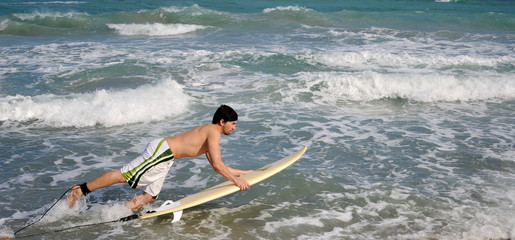 Surfer Jumping into the Water