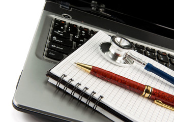 stethoscope at notebook laptop isolated on white