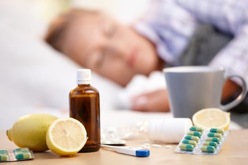 Vitamins medicines for flu woman in background - obrazy, fototapety, plakaty