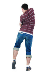 Young man dancing. Rear view.