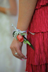 female hand with wedding flower on wrist