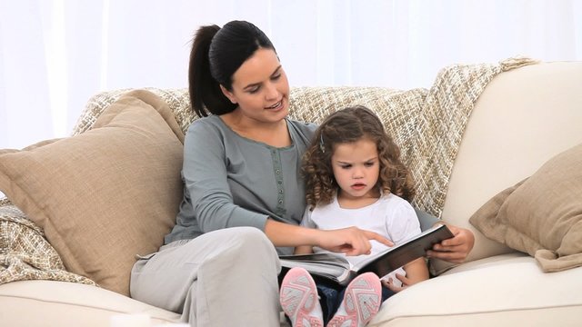 Mother and daughter looking at an album