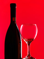 A bottle of red wine and wine glass