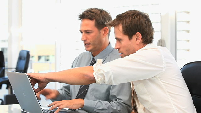Coworkers working together on a laptop