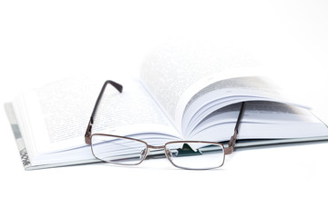glasses on an open book