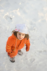 Fototapeta na wymiar little girl playing on the snow