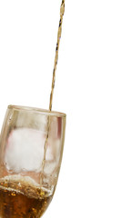 Alcohol drink pours into the glass isolated over white