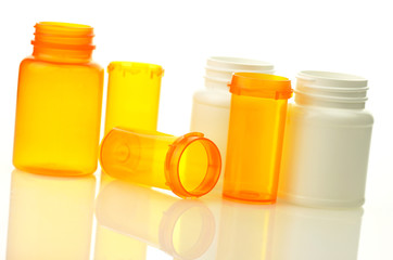 Empty pill bottles on white background.