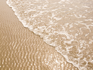 Foamy Ocean Shoreline at a Sunny Beach