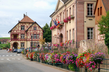 Fototapeta na wymiar France, Mayoralty building decorated with flowers in Riquewihr
