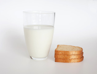 pieces of dried bread and glass of milk