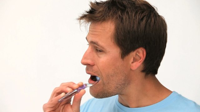 Handsome man brushing his teeth