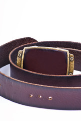 Belt strap and buckle wrapped up on a white background