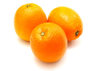 Three ripe oranges lie nearby on a white background