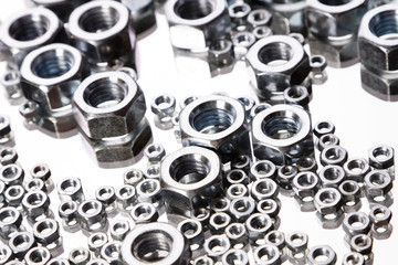 Screws and nuts top view in mirror