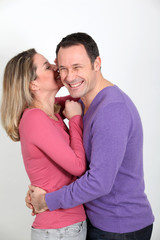 Woman whispering to her boyfriend's ear