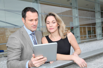 Business partners working on electronic pad