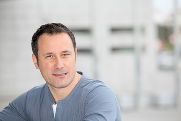 Portrait of hansome man standing in the street