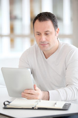Office worker in the office using electronic tab