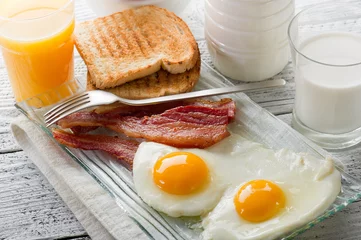 Fototapete Spiegeleier eggs with bacon-uova con bacon