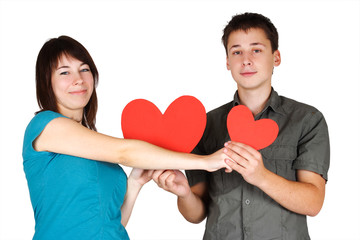 beauty girl and man holding two paper hearts, smiling and lookin